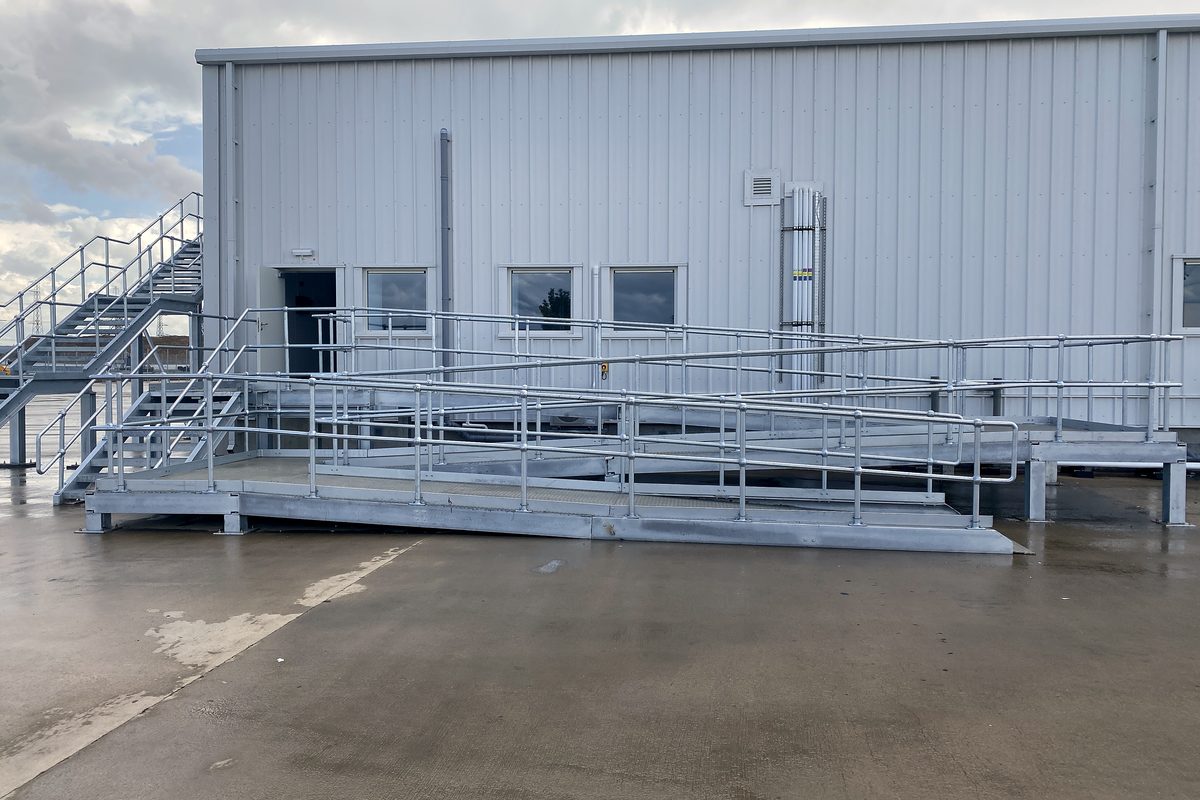 Galvanised steel stairs, ramp and handrails outside an industrial unit